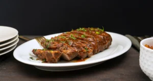 A tender and juicy slice of slow-cooked brisket garnished with fresh parsley, served with savory juices from the slow cooker.