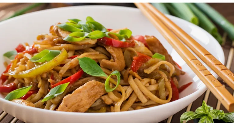 Plate of Thai Drunken Noodles featuring stir-fried rice noodles fresh basil, Thai bird's eye chili