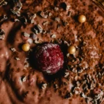 A serving of Belgian chocolate mousse topped with chocolate shavings, cocoa powder