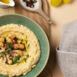 Homemade classic hummus served with pita bread and fresh vegetables.