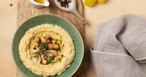 Homemade classic hummus served with pita bread and fresh vegetables.