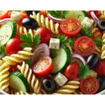 A bowl of freshly prepared pasta salad with rotini pasta, cherry tomatoes, cucumber, red bell pepper, red onion, black olives, and crumbled feta cheese, garnished with fresh parsley and drizzled with olive oil-based dressing.