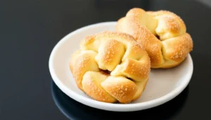 Delicious cruffins with flaky layers and a jam filling, fresh from the oven.