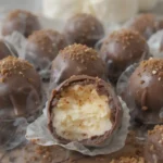 A plate of homemade Tiramisu Truffles dusted with cocoa powder and coated in dark chocolate, arranged in an elegant, bite-sized display.